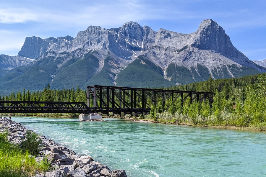 The Bow River and train bridge in Canmore, Alberta