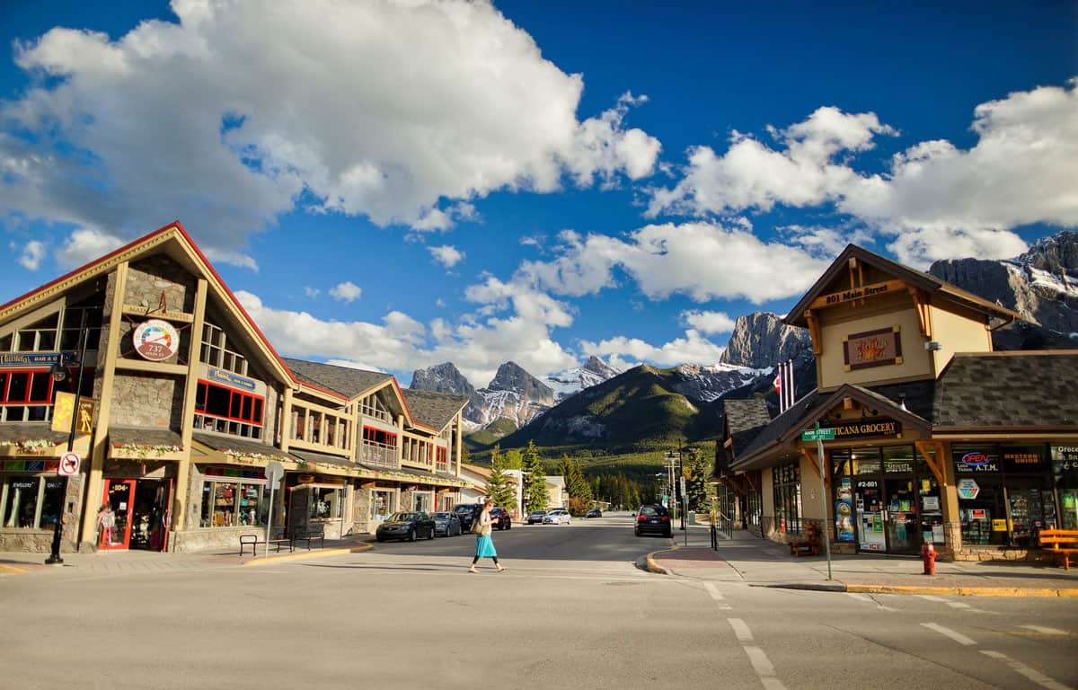 The shops of main street Canmore with the Three Sisters mountains in the background.