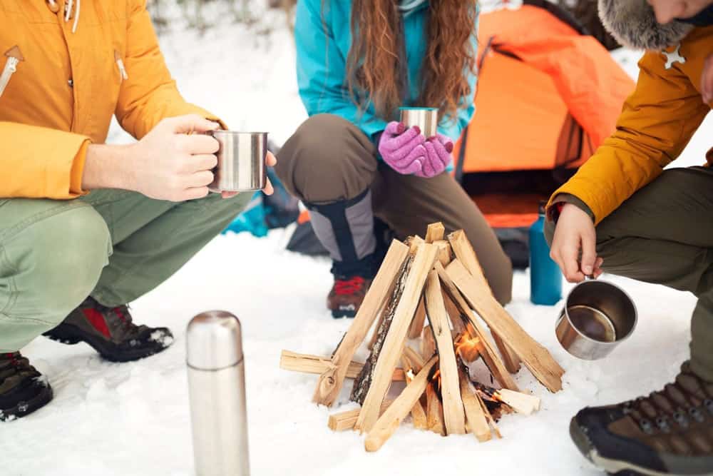 Winter camping starting a campfire