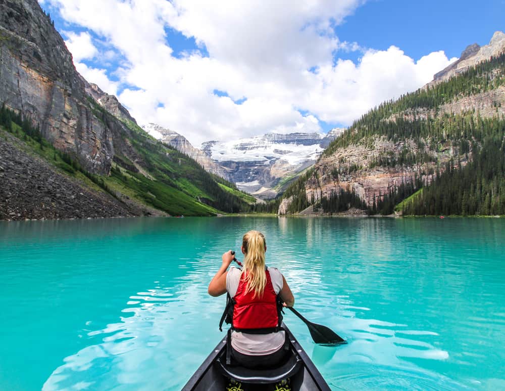 A woman paddling a canoe on Lake Louise