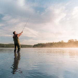 A fisherman casts a line in Alberta
