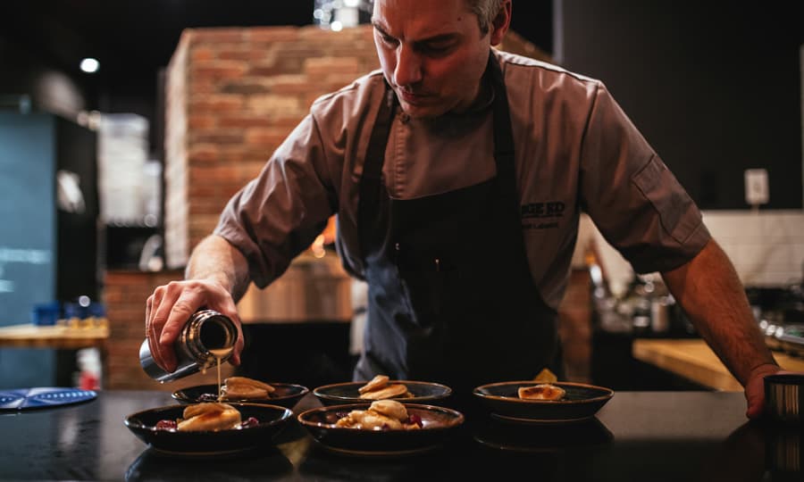 A chef prepares dishes in Edmonton, Alberta