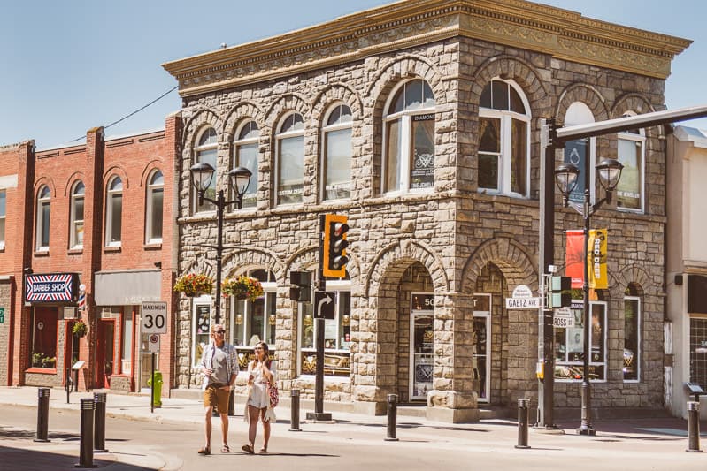 A couple crosses the street on Red Deer's 50th Street Corner