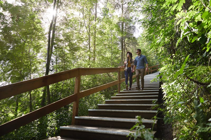 A couple walk on a trail in Red Deer