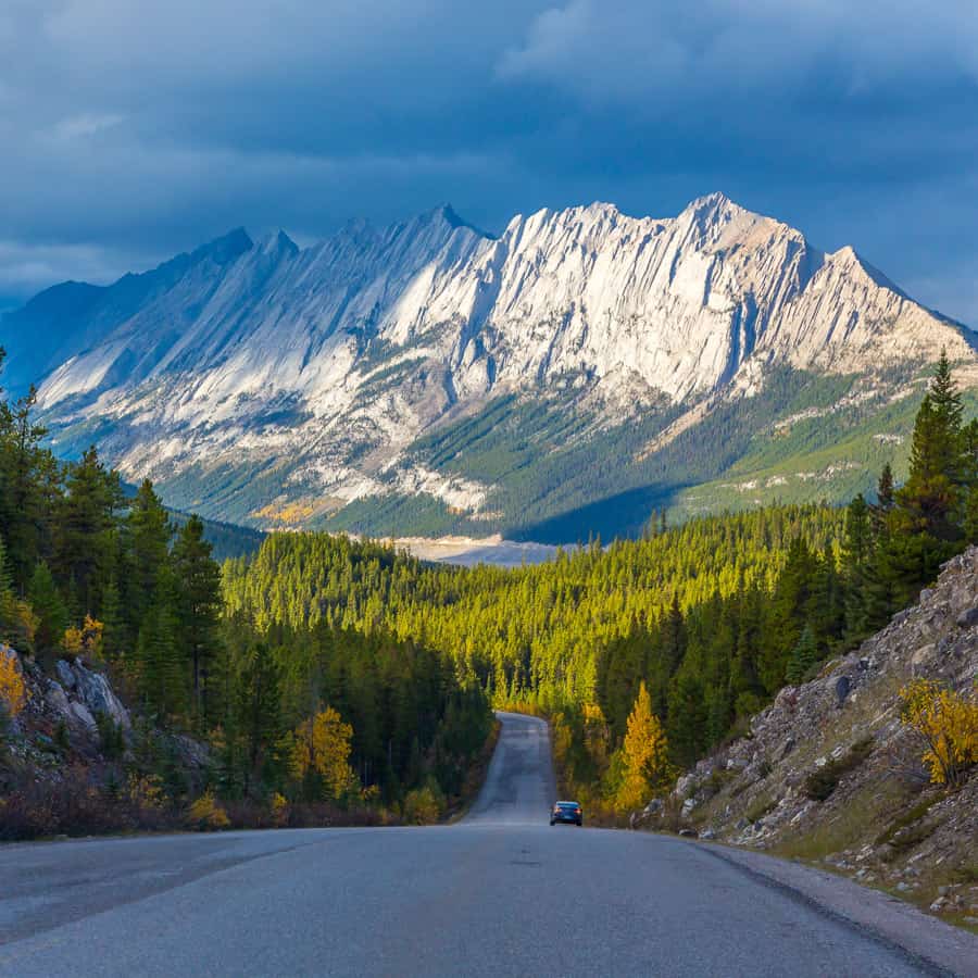 The Road that leads to Jasper with the Rocky Mountains in the distance.