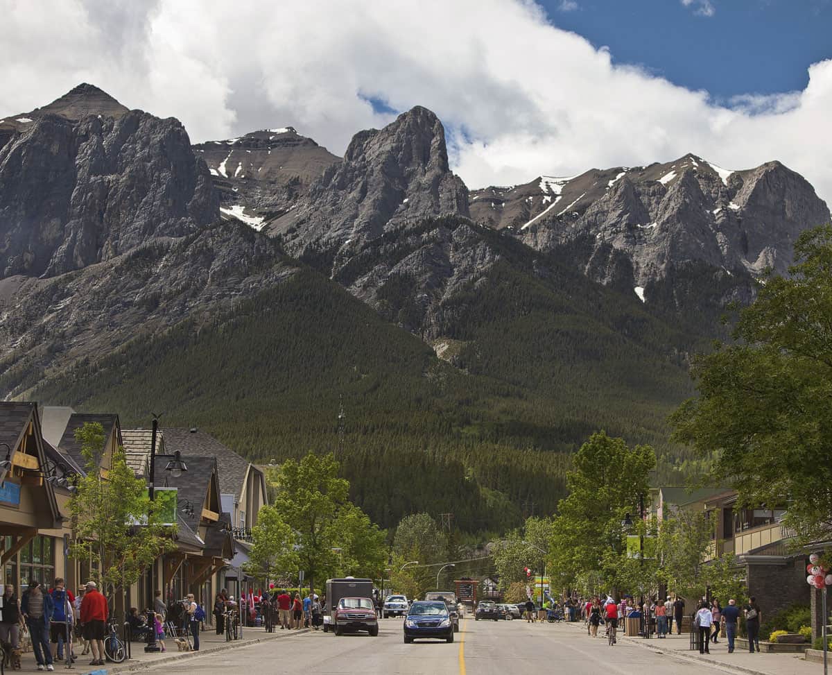 Cars drive down main street Canmore