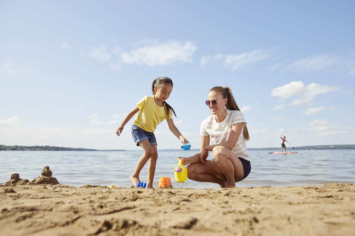 A mother and daughter on the beach at Sylvan Lake