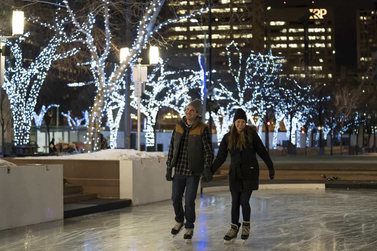 A couple ice skating in downtown Edmonton