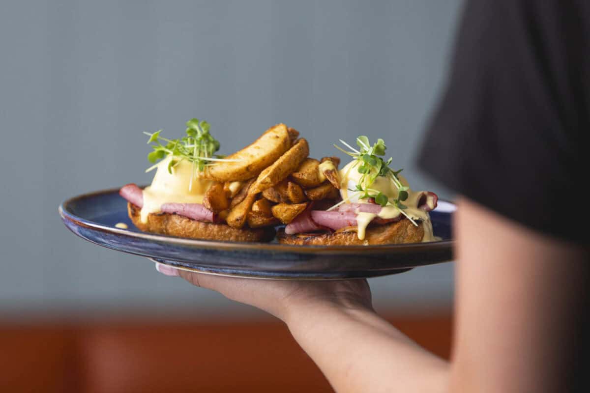 A server brings a breakfast meal at OEB in Calgary